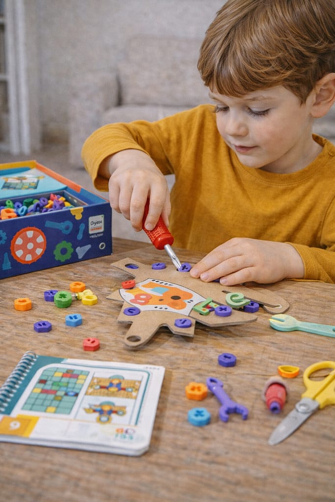Comparatif des kits créatifs éducatifs par âge : bricolage, art et manipulation enfant réalise une activité créative éducative avec un kit de bricolage